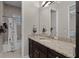 Bathroom featuring granite counters, dark wood cabinets, and a shower/tub combination at 11755 Waterstone Loop Dr, Windermere, FL 34786