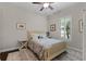 Cozy bedroom with light-colored walls, a ceiling fan, and natural light from a window at 11755 Waterstone Loop Dr, Windermere, FL 34786
