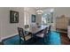 Bright dining room featuring a modern light fixture, plantation shutters and a vibrant blue rug at 11755 Waterstone Loop Dr, Windermere, FL 34786