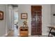 Elegant entryway featuring a wooden door, decorative table, and view into the bedroom at 11755 Waterstone Loop Dr, Windermere, FL 34786