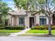 Inviting single-story home with manicured lawn, brick walkway, and well-maintained landscaping at 11755 Waterstone Loop Dr, Windermere, FL 34786