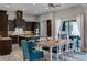 Spacious kitchen and dining area featuring dark cabinets, granite countertops, and stainless steel appliances at 11755 Waterstone Loop Dr, Windermere, FL 34786
