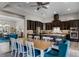 Open-concept kitchen and dining area with dark cabinets, a large island, and modern fixtures at 11755 Waterstone Loop Dr, Windermere, FL 34786