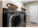 Laundry room showcasing a stainless steel washer and dryer with white cabinets at 11755 Waterstone Loop Dr, Windermere, FL 34786
