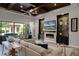 Spacious living room features a fireplace, built-in shelving, and sliding doors to the backyard at 11755 Waterstone Loop Dr, Windermere, FL 34786