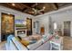 Bright living room with a stone-accented fireplace, coffered ceilings, and stylish decor at 11755 Waterstone Loop Dr, Windermere, FL 34786