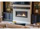 Inviting living room with a cozy fireplace, built-in shelving, and stylish decor at 11755 Waterstone Loop Dr, Windermere, FL 34786