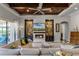 Open-concept living room with a coffered ceiling, fireplace, and comfortable seating at 11755 Waterstone Loop Dr, Windermere, FL 34786
