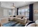 Bright living room features a large window, plush seating, and stylish decor for a comfortable gathering space at 11755 Waterstone Loop Dr, Windermere, FL 34786