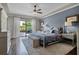 Comfortable bedroom with stylish decor, plush carpeting, and sliding glass doors to the outdoor patio at 11755 Waterstone Loop Dr, Windermere, FL 34786