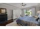 Inviting bedroom featuring hardwood floors, a large window, and access to a pool-view patio at 11755 Waterstone Loop Dr, Windermere, FL 34786
