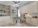 Bright office with custom cabinets, built-in shelving, desk, and a comfortable chair at 11755 Waterstone Loop Dr, Windermere, FL 34786