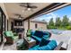 Covered patio with comfortable wicker seating and ceiling fans overlooking the pool, creating a perfect outdoor living space at 11755 Waterstone Loop Dr, Windermere, FL 34786