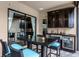 Inviting patio with a dining set, outdoor kitchen, and sliding glass doors at 11755 Waterstone Loop Dr, Windermere, FL 34786