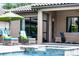 Covered patio with stylish seating beside a beautiful pool at 11755 Waterstone Loop Dr, Windermere, FL 34786