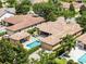 Aerial view of a beautiful home showcasing the pool, backyard, lush landscaping, and privacy hedges at 11755 Waterstone Loop Dr, Windermere, FL 34786