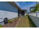 The backyard features a screened-in porch, manicured lawn, and a white fence for privacy at 1212 Civitas Way, Winter Garden, FL 34787