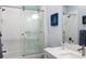 Bathroom showcasing a shower with glass door and modern fixtures, complemented by a pristine white vanity at 1212 Civitas Way, Winter Garden, FL 34787