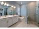 Modern bathroom with double vanity, soaking tub, and glass-enclosed shower, perfect for relaxation at 1212 Civitas Way, Winter Garden, FL 34787