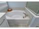 Close-up view of the bathtub with tile surround, faucet and fixtures with view of glass enclosed shower at 1212 Civitas Way, Winter Garden, FL 34787