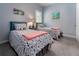Bright bedroom with two beds, gray carpeting, and matching decor, creating a serene and inviting space at 1212 Civitas Way, Winter Garden, FL 34787