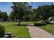 Scenic Oakland Park green space featuring a walking trail, mature trees and manicured lawns at 1212 Civitas Way, Winter Garden, FL 34787