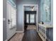 Bright entryway with shuttered front door, opening to a view of a stylishly decorated room at 1212 Civitas Way, Winter Garden, FL 34787