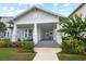 Charming home featuring a inviting covered porch, craftsman details and a beautifully landscaped front yard at 1212 Civitas Way, Winter Garden, FL 34787