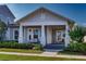 Charming single-story home featuring a welcoming front porch, manicured lawn, and attractive architectural details at 1212 Civitas Way, Winter Garden, FL 34787