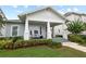 Inviting home featuring a charming covered front porch and meticulously landscaped front yard at 1212 Civitas Way, Winter Garden, FL 34787