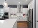 Modern kitchen featuring stainless appliances, white cabinetry, and hardwood floors at 1212 Civitas Way, Winter Garden, FL 34787