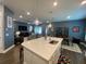 Open-concept kitchen with a large island, pendant lighting, and sleek stainless steel appliances at 1212 Civitas Way, Winter Garden, FL 34787