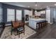 Bright open-concept kitchen with an island bar, stainless appliances, white cabinets, and a connected dining area at 1212 Civitas Way, Winter Garden, FL 34787