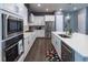 Bright kitchen with white cabinets, stainless steel appliances, and a quartz countertop at 1212 Civitas Way, Winter Garden, FL 34787