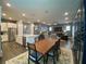 Open-concept kitchen and dining area featuring stainless appliances and a large wooden table at 1212 Civitas Way, Winter Garden, FL 34787