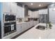 Stylish kitchen with stainless steel appliances, white cabinets, and a large center island at 1212 Civitas Way, Winter Garden, FL 34787