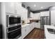 Bright kitchen with stainless appliances, white cabinetry, and hardwood floors at 1212 Civitas Way, Winter Garden, FL 34787