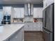 Modern kitchen with white cabinets, stainless steel appliances, and a spacious island with a quartz countertop at 1212 Civitas Way, Winter Garden, FL 34787