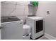 Modern laundry room with new washer and dryer, storage shelves, and organized laundry baskets at 1212 Civitas Way, Winter Garden, FL 34787