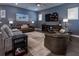 Cozy living room features hardwood floors, a ceiling fan, a large TV, and comfortable seating at 1212 Civitas Way, Winter Garden, FL 34787