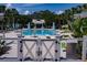 Community pool area surrounded by lounge chairs and palm trees at 1212 Civitas Way, Winter Garden, FL 34787