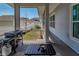 Covered lanai featuring a grill and view of a fenced yard. Ideal for relaxation and entertaining at 1212 Civitas Way, Winter Garden, FL 34787