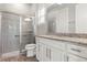 Modern bathroom featuring a walk-in shower with glass doors, granite countertops, and elegant fixtures at 1272 Patterson Ter, Lake Mary, FL 32746