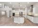 Bright kitchen features white cabinets, stainless appliances, mosaic backsplash and a large center island at 1272 Patterson Ter, Lake Mary, FL 32746