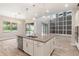 Bright and airy kitchen with a large island, stainless steel appliances, and an open view to living room at 1272 Patterson Ter, Lake Mary, FL 32746