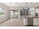 Bright kitchen features white cabinets, stainless appliances, mosaic backsplash and a large center island at 1272 Patterson Ter, Lake Mary, FL 32746