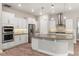 Modern kitchen with white cabinetry, stainless steel appliances, and a stylish backsplash at 1272 Patterson Ter, Lake Mary, FL 32746