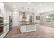 Contemporary kitchen with white cabinets, a central island, stainless appliances and adjacent living room at 1272 Patterson Ter, Lake Mary, FL 32746