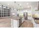 Bright kitchen features white cabinets, stainless appliances, mosaic backsplash and a large center island at 1272 Patterson Ter, Lake Mary, FL 32746