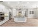 Modern kitchen featuring stainless steel appliances, a large island, and pendant lighting at 1272 Patterson Ter, Lake Mary, FL 32746